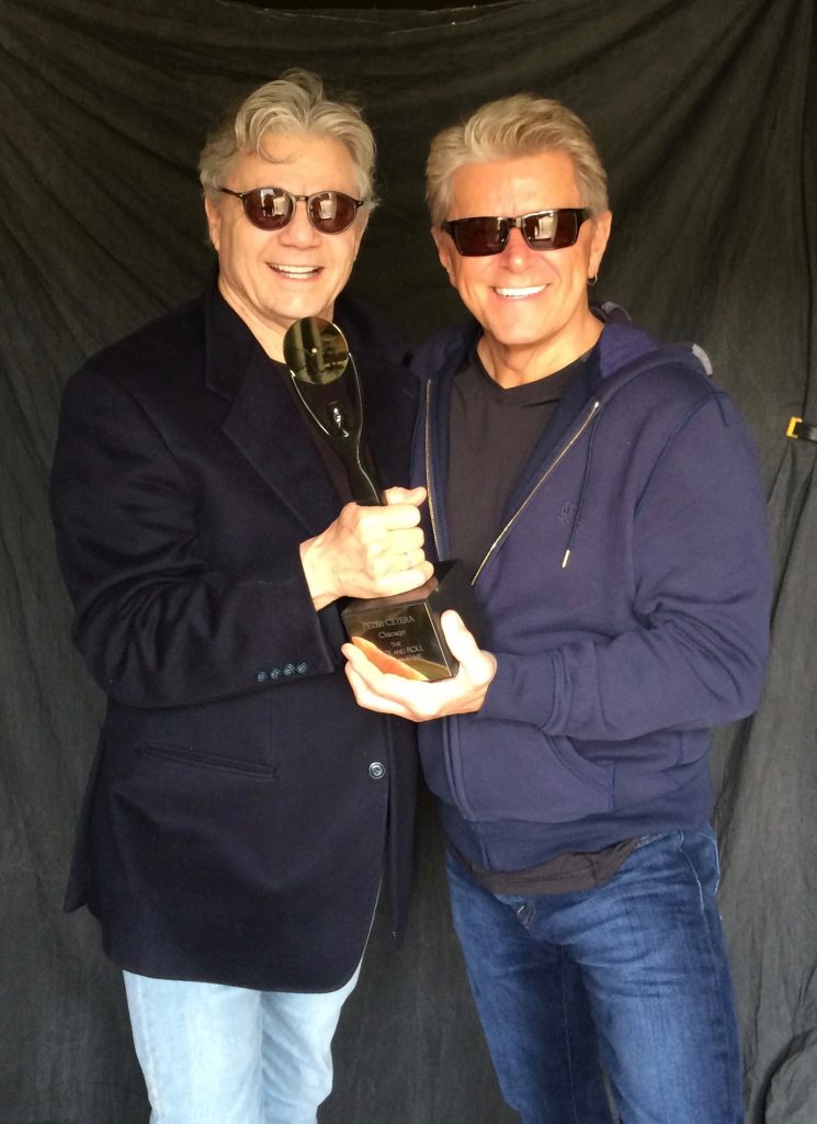 Miller and Cetera displaying Cetera's Rock Hall trophy (via PeterCetera.com)